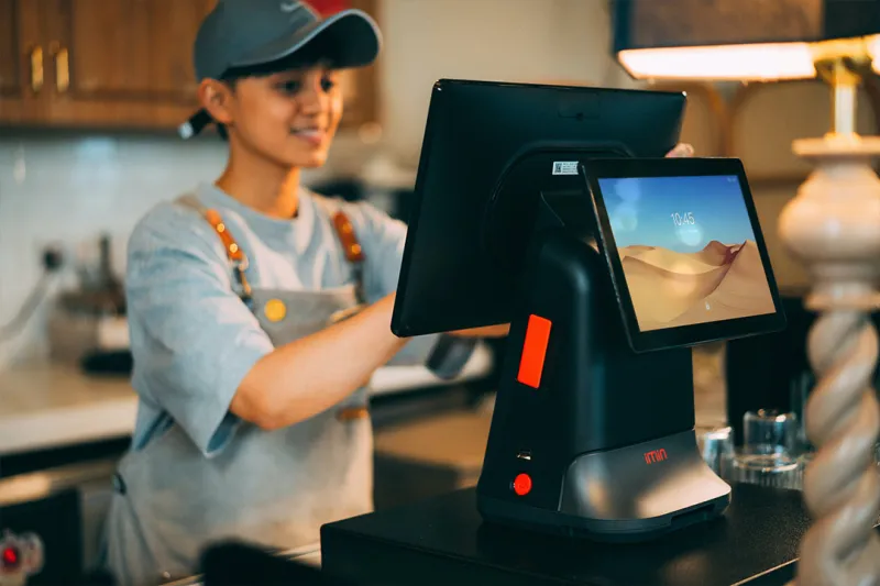 How to choose a payment processor for retail business showing merchant using EPOS terminal at counter
