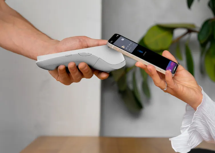 Person making contactless payment using mobile device - payment gateway comparison API integration example