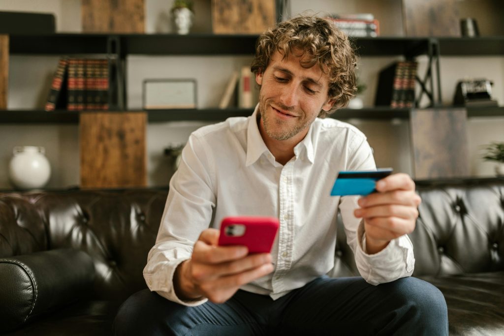 Person holding debit card for card processing rates Ireland 2025 analysis showing merchant service rates Ireland comparison