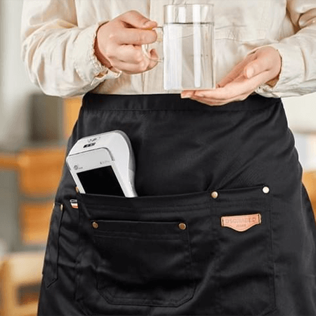 Waiter with PAX A920 card machine in apron pocket demonstrating card terminal rental Ireland mobility solution