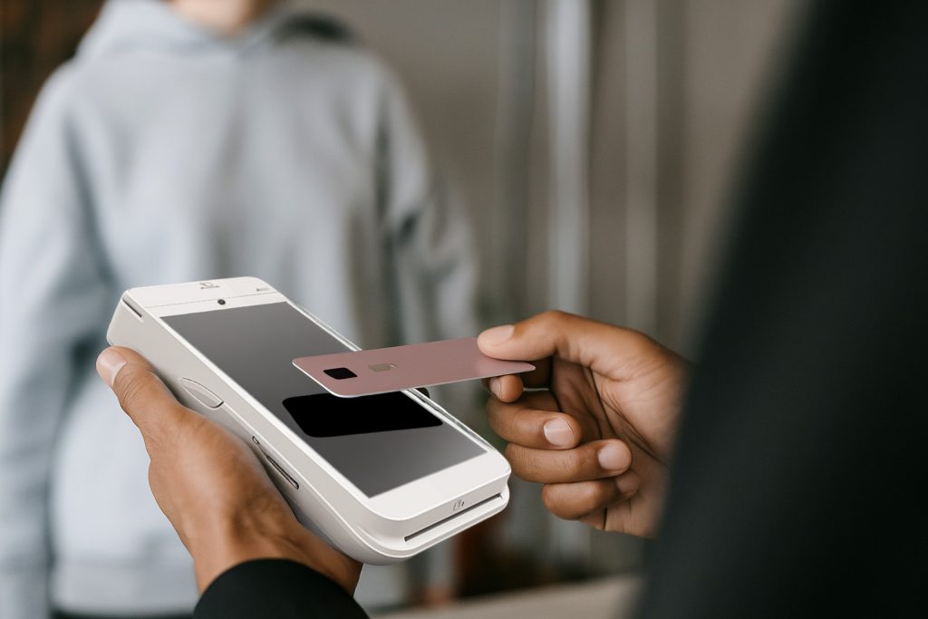 Person holding PAX A920 PRO processing debit card payment showing credit card processing fees Ireland cost differences