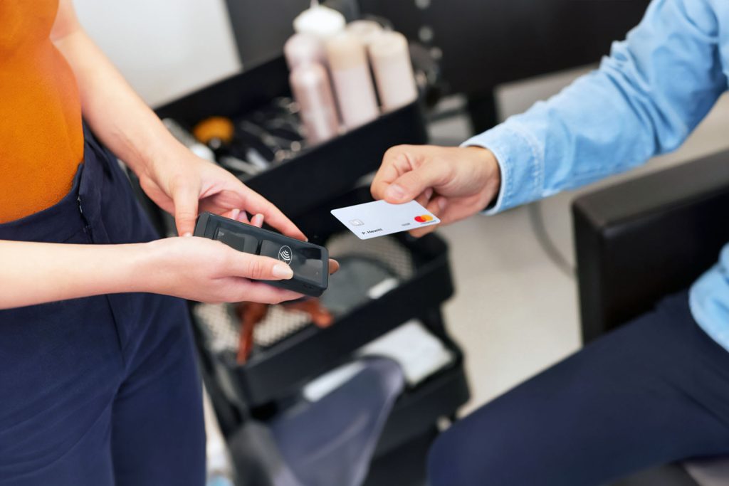 Customer making contactless payment at beauty salon showing salon payments Ireland appointment booking integration benefits