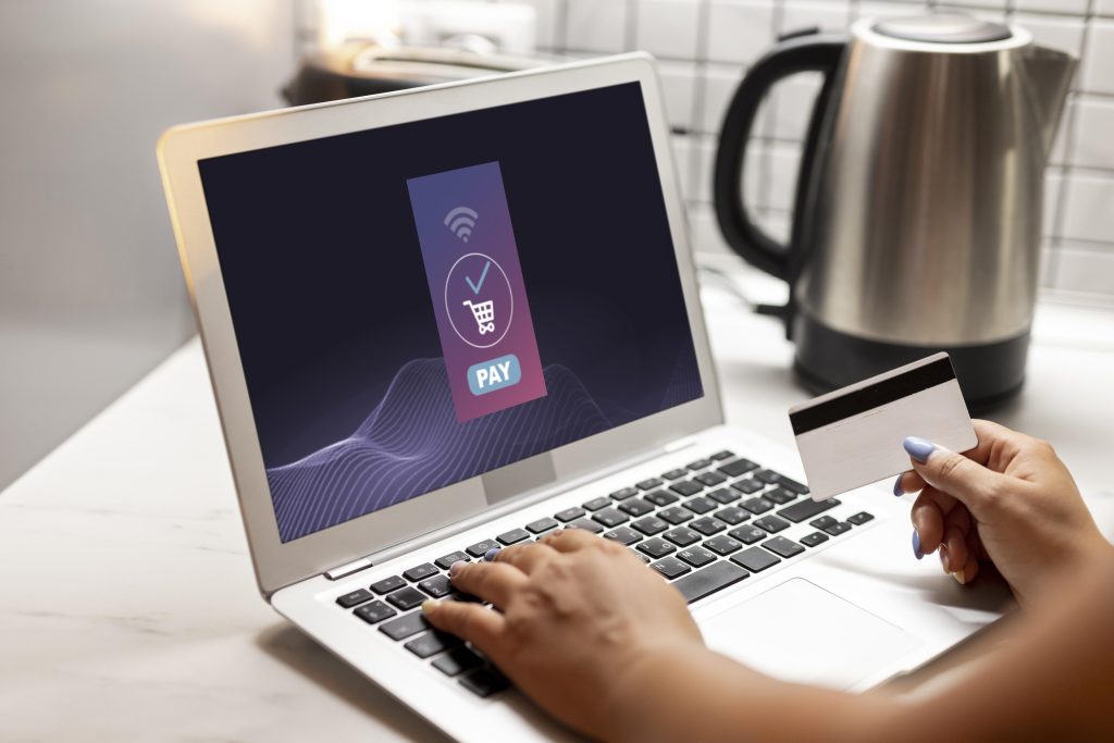 Person making online payment on laptop using online payment gateway Ireland system for secure e-commerce transaction