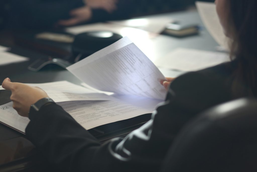 Business owner completing PCI compliance Ireland paperwork and payment security assessment documentation