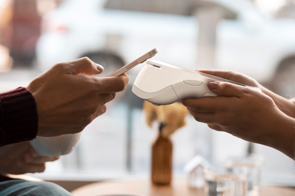 Customer making contactless payment with PAX A920 PRO card machine whilst payment processing support Ireland ensures smooth transaction