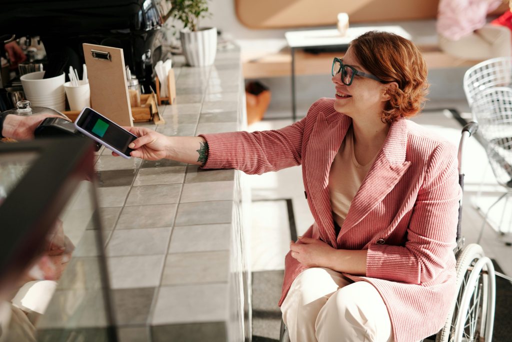 Customer making contactless payment at restaurant counter using hospitality POS system in Ireland