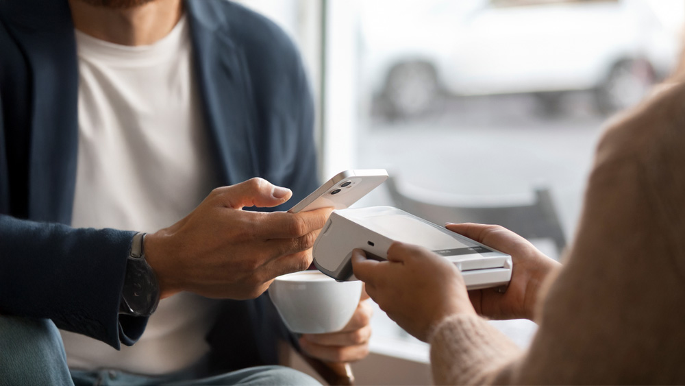 Person making contactless payment on card terminal representing starting business Ireland 2026 with new business payment processing setup