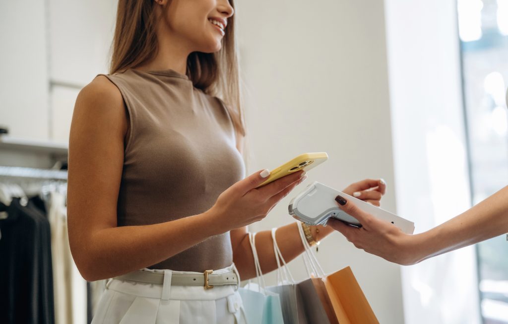 Customer making contactless payment showing payment metrics Ireland tracking with merchant services KPIs for approval rates and transaction time