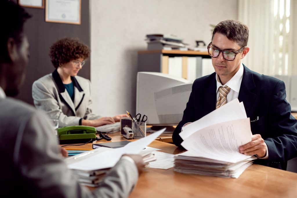 Irish solicitor reviewing client payment documents and trust account records for professional services billing