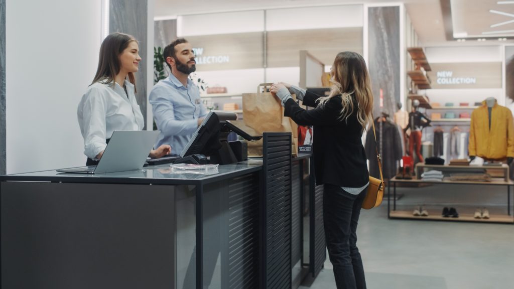 Clothing store checkout cashier counter for January sales Ireland processing post-Christmas returns and refund processing Ireland transactions