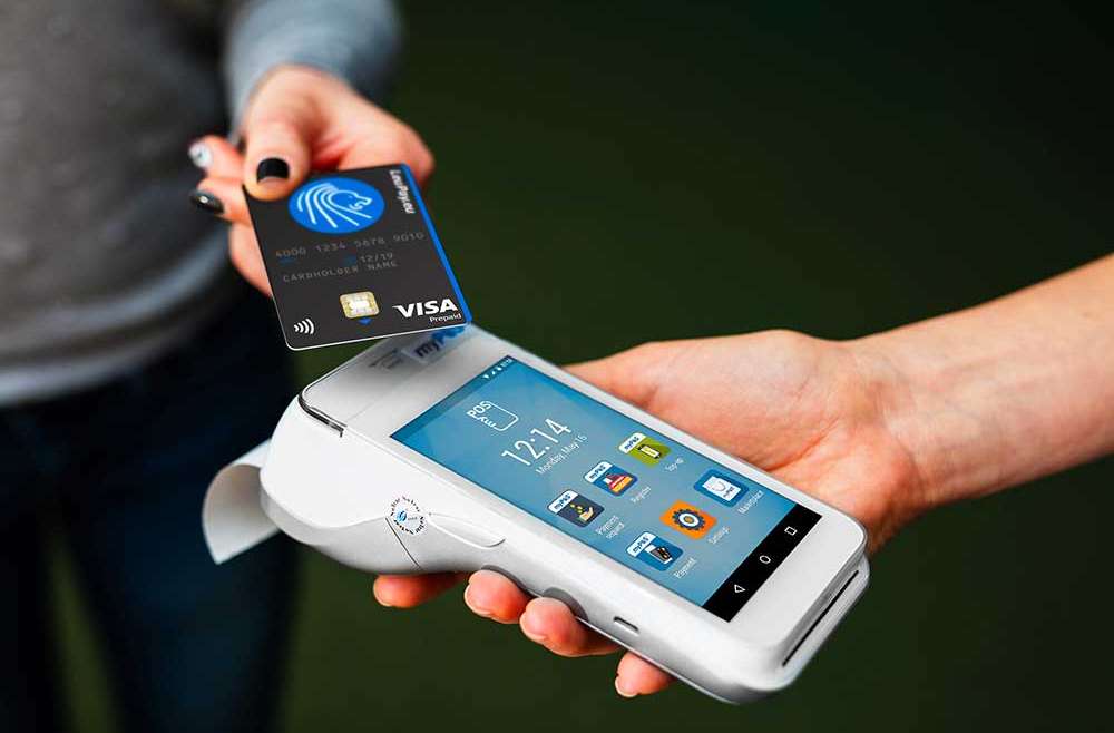 Small business owner accepting a contactless card payment on a myPOS card machine in Ireland