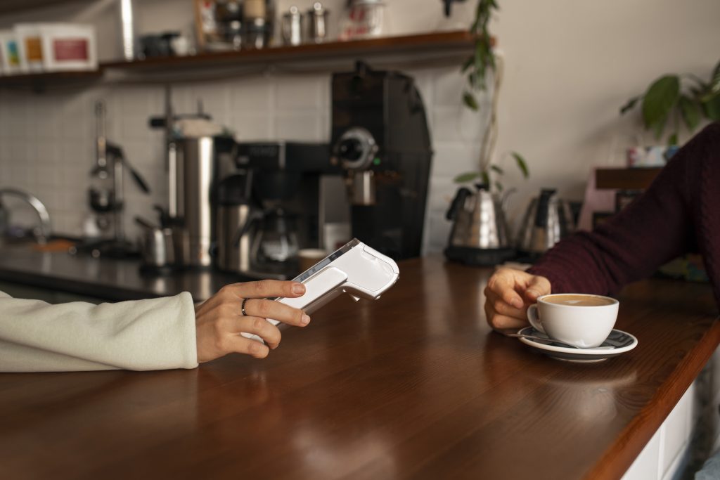 Person making contactless payment with mobile card reader demonstrating card machine low volume Ireland solution for occasional card payments