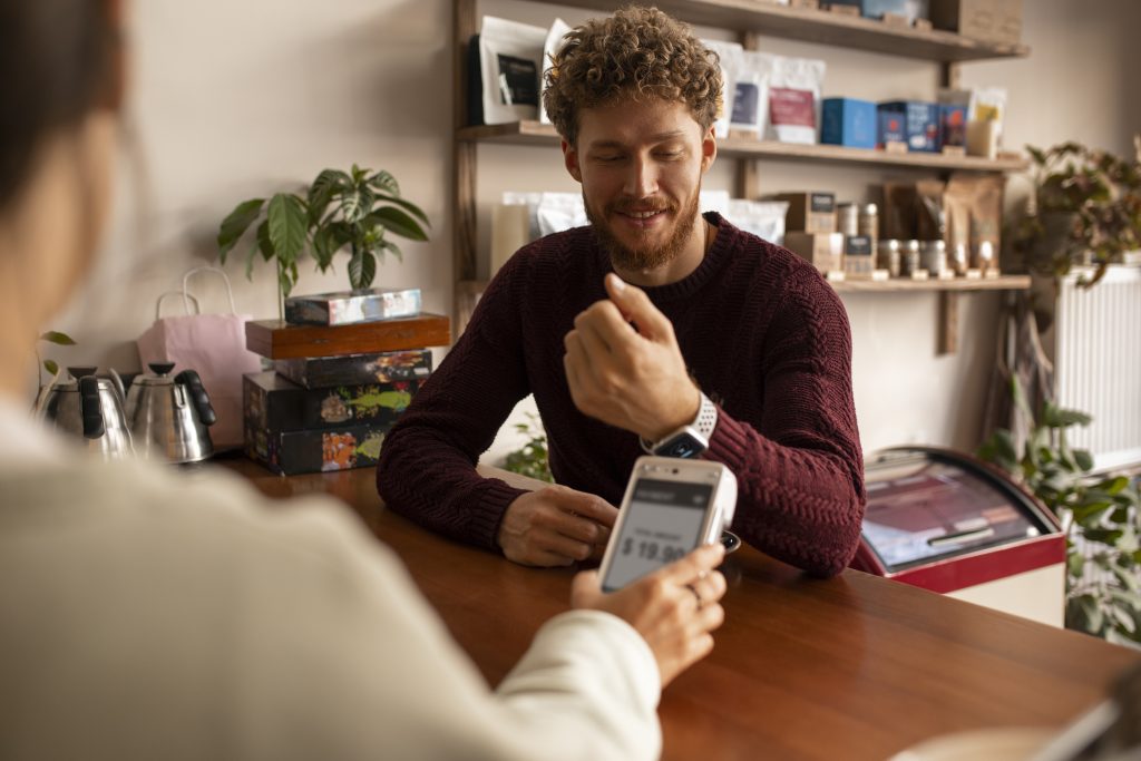 Person making contactless payment on PAX A920PRO terminal demonstrating card machine fees Ireland transaction processing with rental equipment