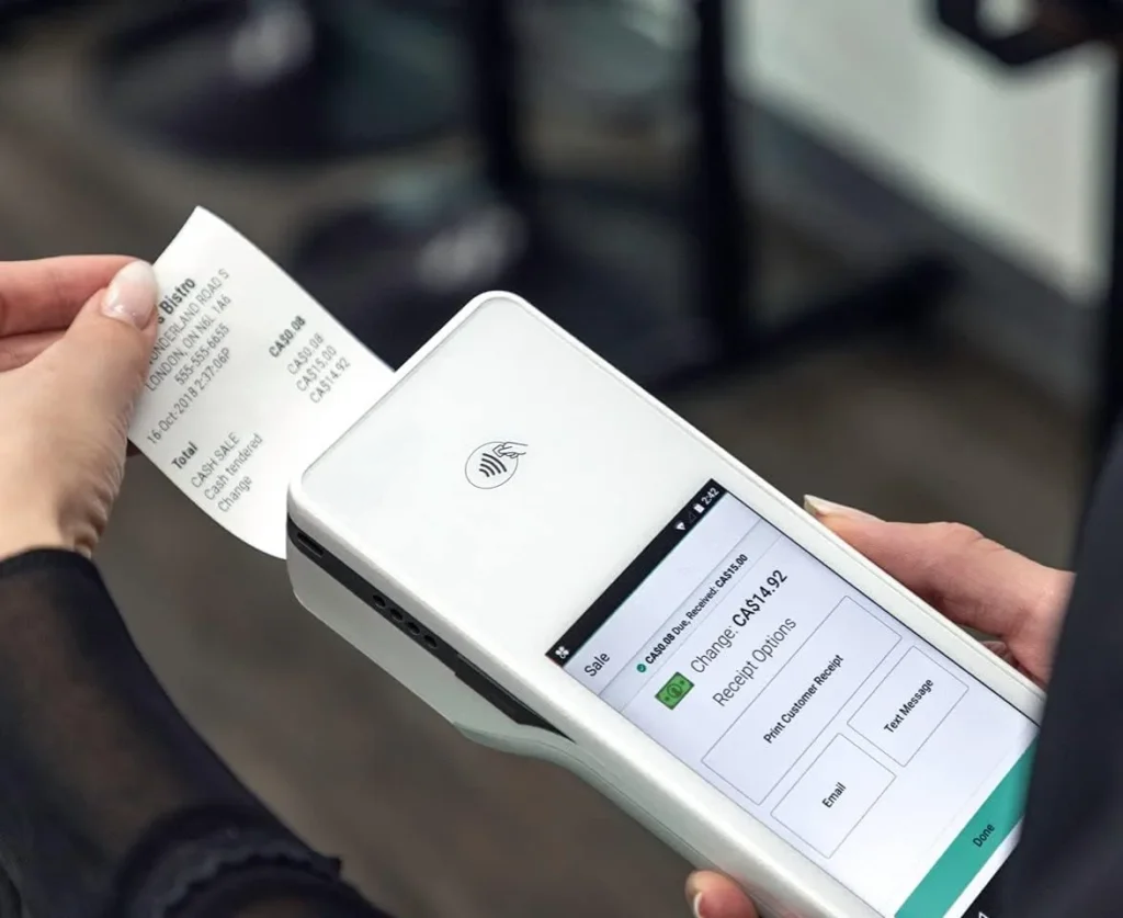 Business owner processing a contactless payment on a Clover Flex smart terminal in Ireland