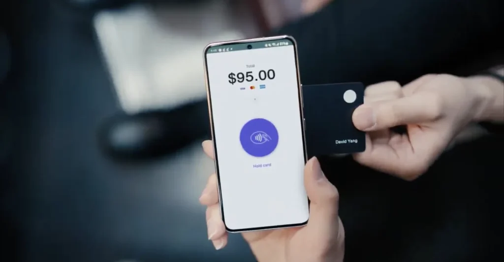 Customer making a contactless payment with a free card machine Ireland at a retail counter
