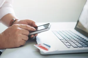 payment link Ireland person paying online with laptop and phone